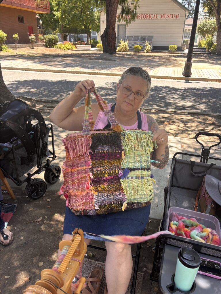 Kelly holding up her patchwork tote bag