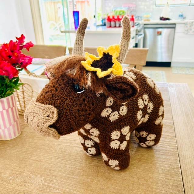 crocheted Highland cow w/ an African flower motif